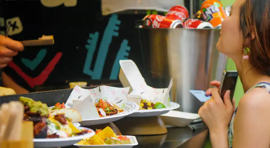 a woman orders from a latin food truck