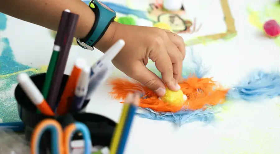a child works on an arts and crafts project at a library